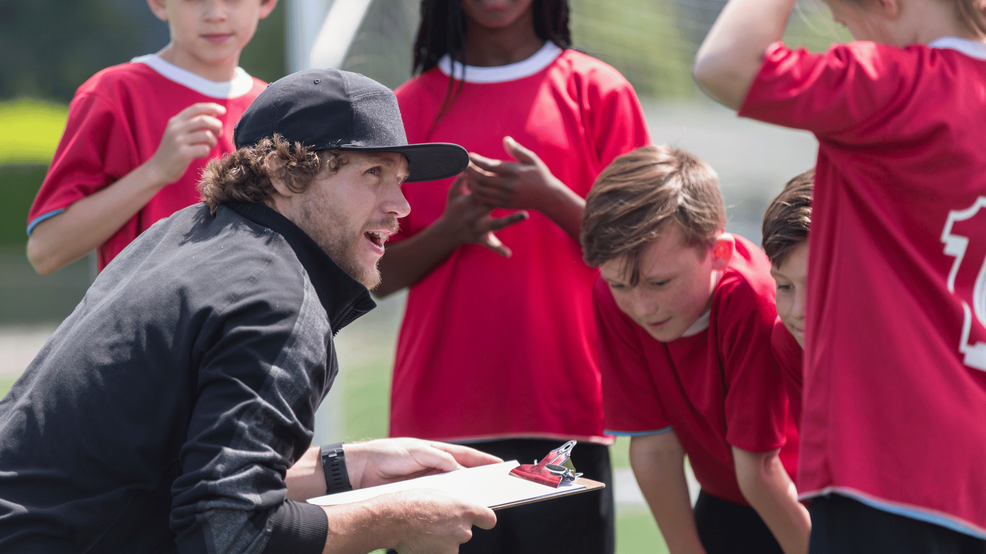 Coach chatting with Kids soccer team