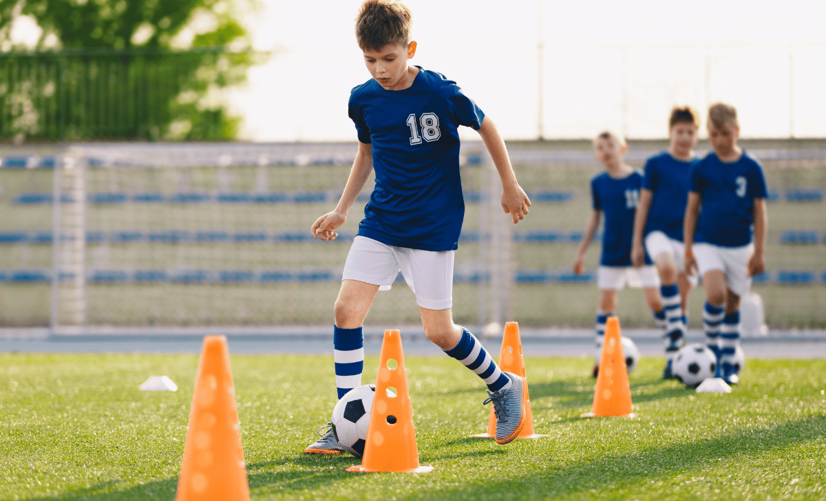 kids doing soccer drills with cones